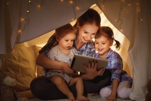 A mother reads a bible story to her kids.