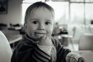 Black and white picture of a baby eating food