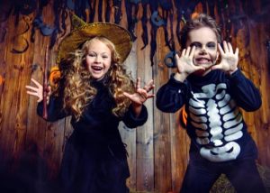 Two kids dressed in Halloween costumes