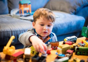 Kid playing with toys inside the house