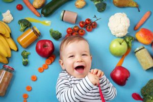 Baby surrounded by food and fruits