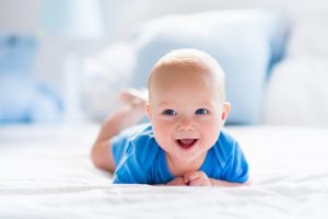 A cute baby boy dressed in blue.