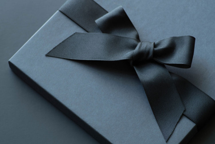 Black gift box wrapped with a black ribbon