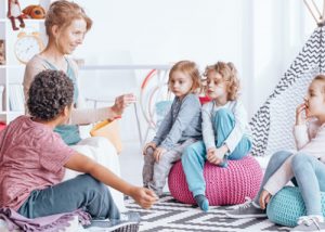 A group of kids participating in a word game.