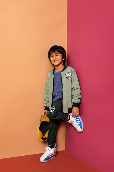 Boy dressed in casual wear and a bomber jacket.