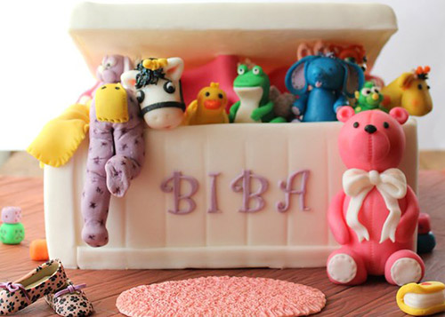 Stuffed toys and plastic animals spilling out of a customised toy box for children. 