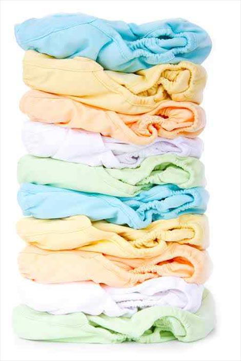 Colourful baby clothes arranged on top of each other