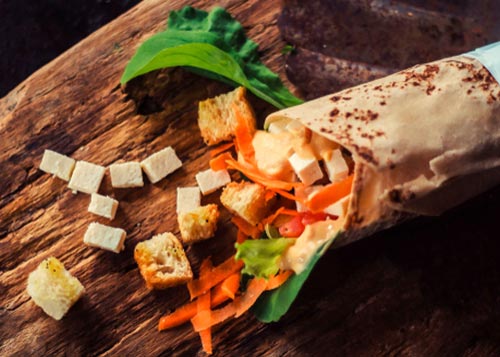 Vegetable, Paneer Frankie served on a wooden plate