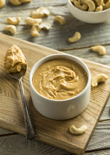 Bowl of cashew butter and a bowl of cashews