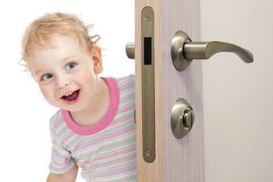 A boy peeking through the door.