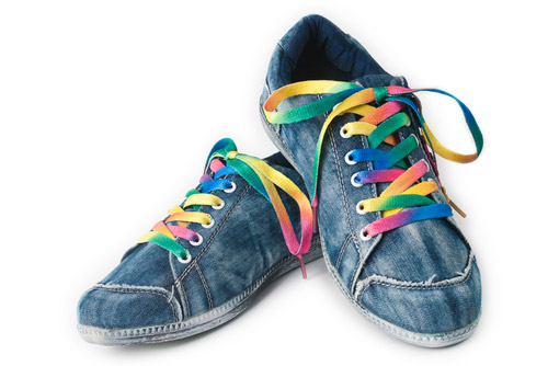  A pair of blue sneakers with colourful shoelaces