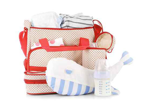 Diaper bag filled with essentials such as baby clothes, feeding bottle, bib