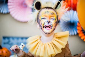 Cheerful young boy in a lion’s costume!