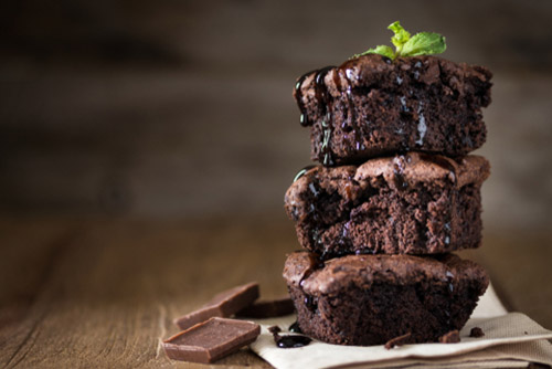 Chocolate brownies stacked one on top of the other.