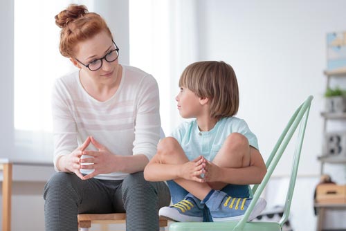 A mother having a serious talk with her son.