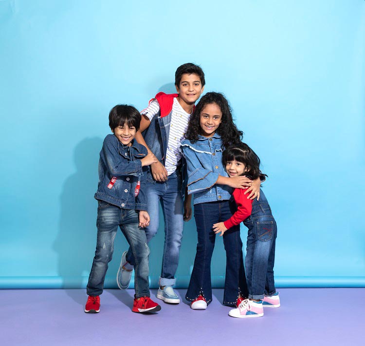 Kids wearing denim huddled together.