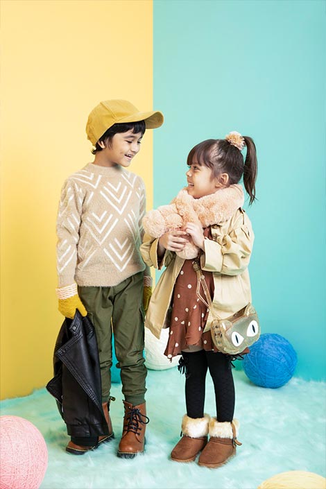 A boy and girl wearing autumn clothes.