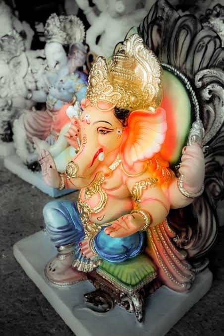 Colourful Lord Ganesha sculpture against a black and white background