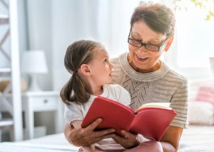 Grandmother reading out stories to Granddaughter
