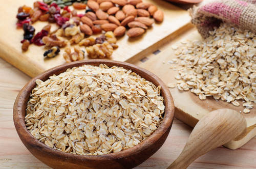 Oats with dry fruits lying next to it