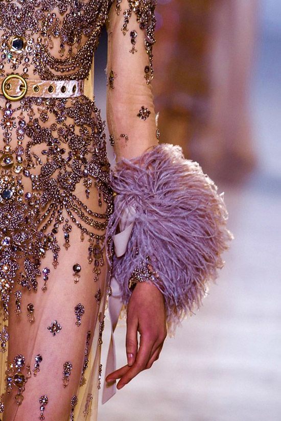 Intricate embellishments on a dress with fur sleeves at the cuff