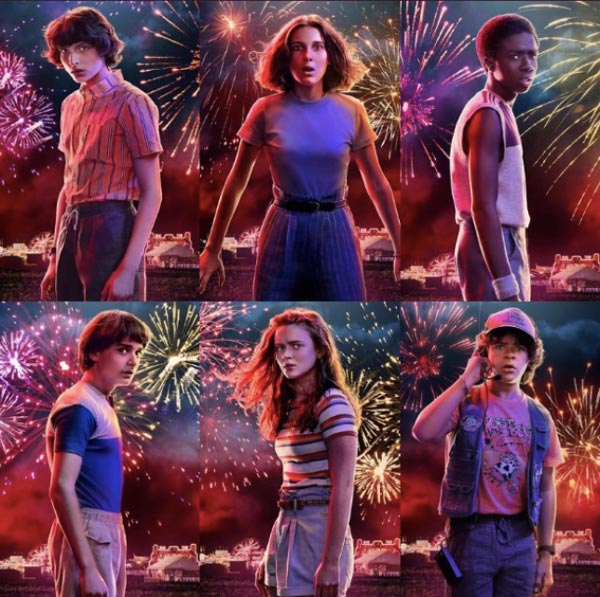 A poster of Stranger Things Season 3 characters Mike, EL, Lucas, Will, Max, and Dustin standing against a background of fireworks.