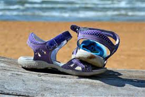  A pair of sandals on the beach.