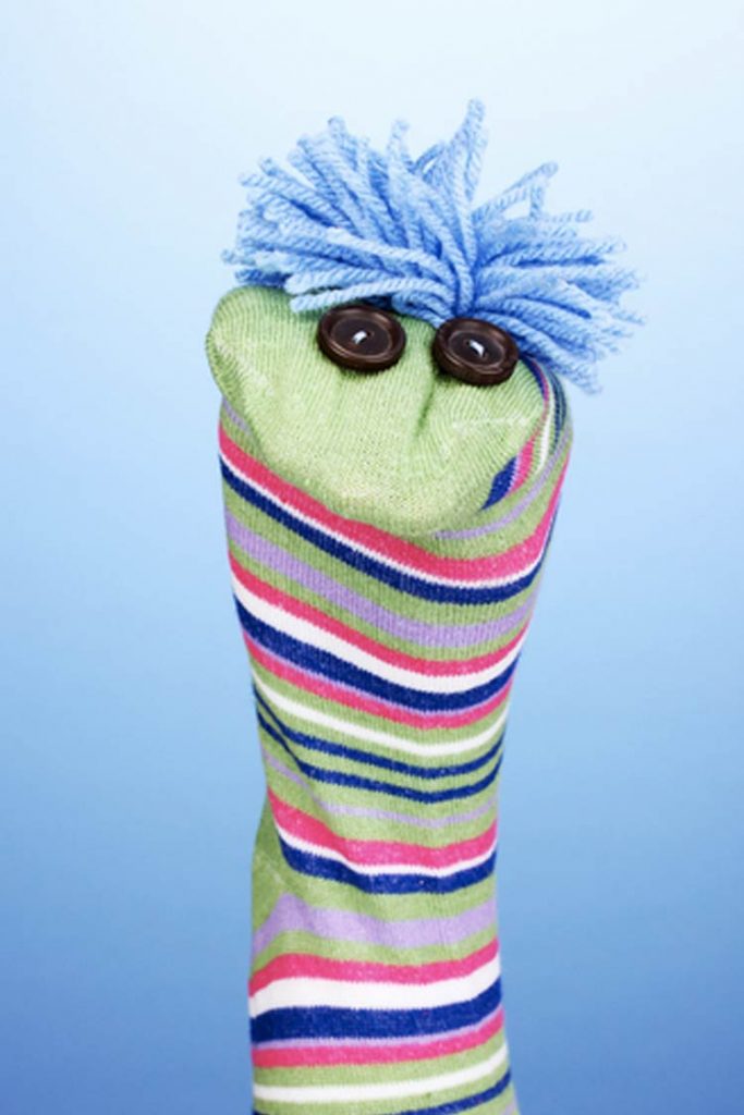  A hand wearing a sock puppet