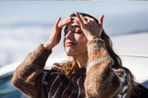 Woman applying sunscreen