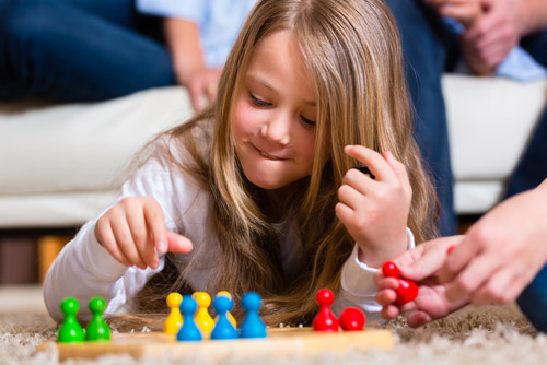Girl playing a board game.