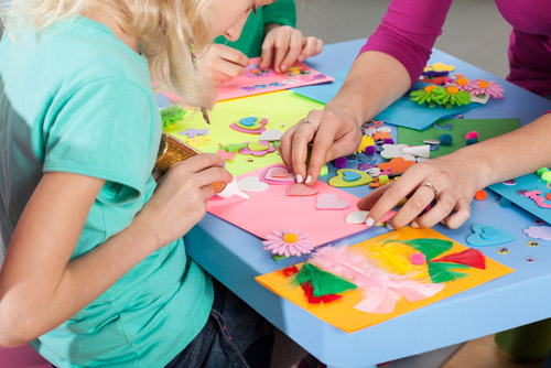 Kids working on art and craft projects.