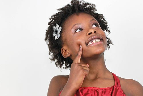 Little girl thinking and staring into the distance