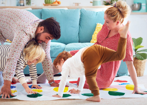 Mom, dad, and two kids playing the game of twister