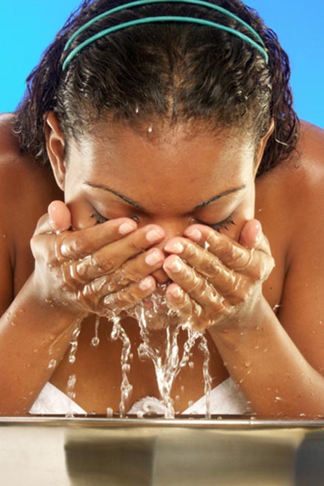 A woman washing her face