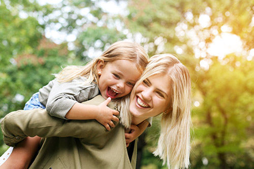 Mom and daughter playing in the park.