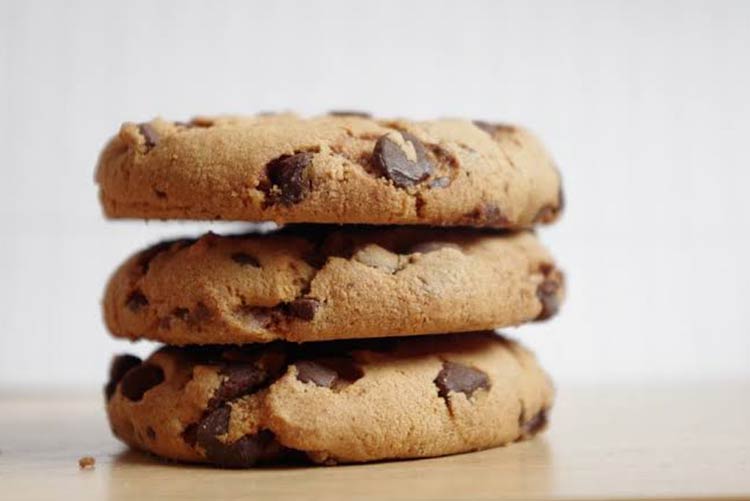 Three chocolate chip cookies stacked on top of each other