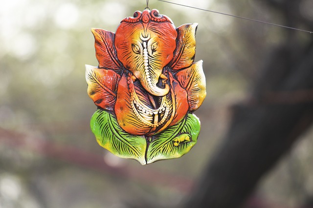 Small Ganesha ornament hanging from a wire