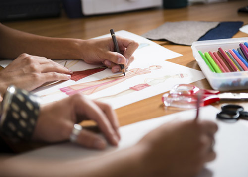 Image of hands sketching designs