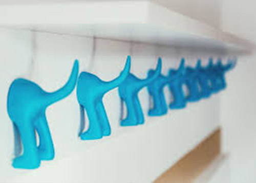 Close up of blue wall hangers hanging on the inside of a white closet door