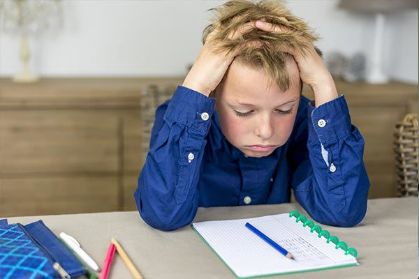 Young boy stressing out over his homework