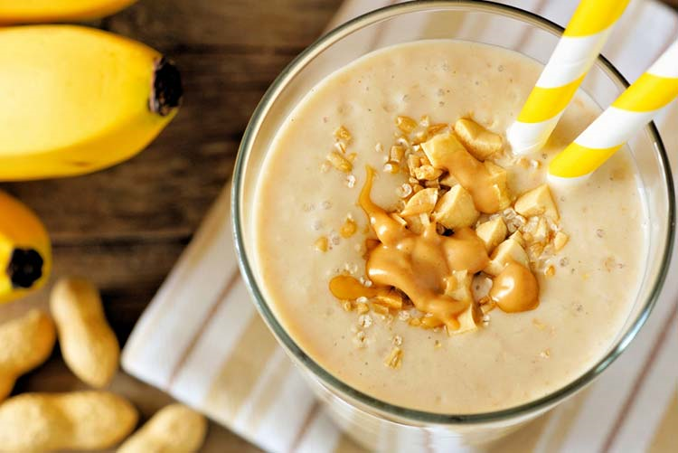 Peanut butter and banana smoothie with almonds placed on the side!