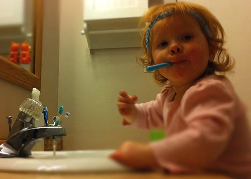 Toddler brushing her teeth