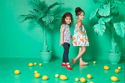 Two young girls in pastel shades posing in front of the camera