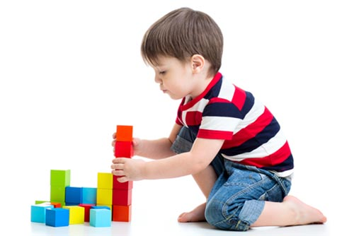Young toddler building colourful blocks