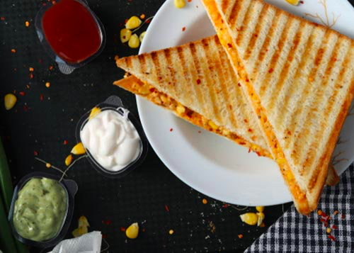 Grilled corn sandwich served with ketchup and dips!