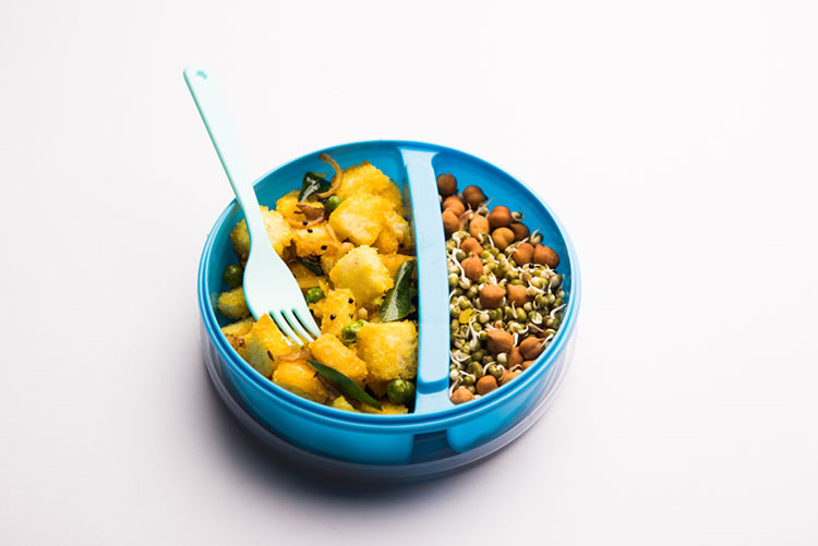 Tiffin box filled with bread upma and sprouts