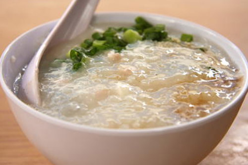 Rice mash with vegetable stock in a bowl