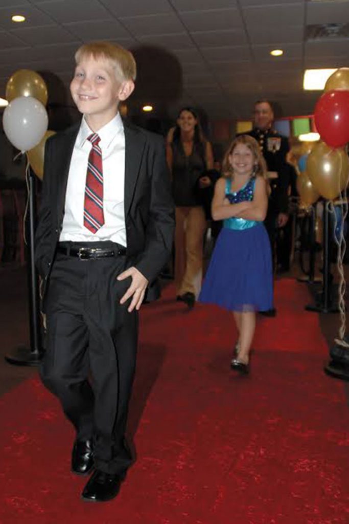 Kids dressed up and walking down the red carpet