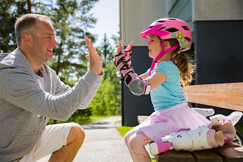 Father high-fiving his daughter