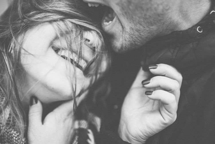 Husband and wife embracing and laughing